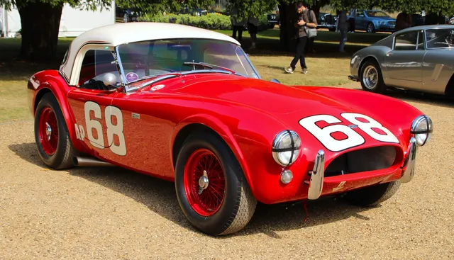 Identified 1962 260 competition Cobra with hardtop, numbers, race lighting, and side exhaust. It appears only as labeled competition history.
