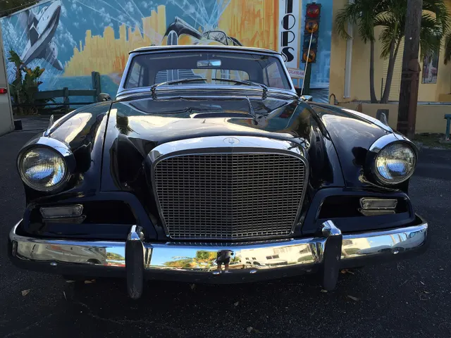 Straight-on front view showing the square-pattern grille without a center emblem, rectangular side lamps, hood form, bumper, and headlamp treatment unique to the first GT Hawk year.