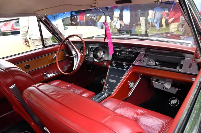 Exact-year Riviera cabin retained for the four-place bucket-seat layout, center console, instrument panel, steering wheel, and door trim; condition and restoration remain specific to the photographed car.