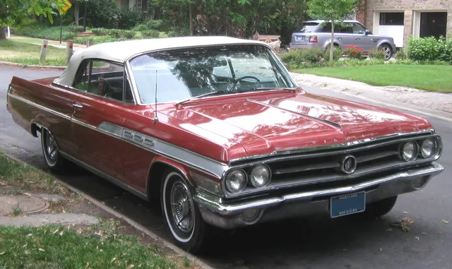 Alternate exact-year convertible view retained for body, grille, trim, lamp, glass, top, and factory-style wheel context; condition remains specific to the photographed car.