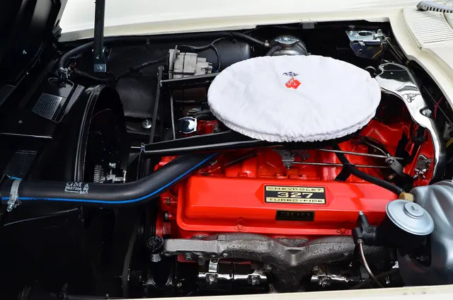 Restored 1963 Corvette 327 engine bay. Reproduction labels, hoses, finishes, and individual components require car-specific inspection.