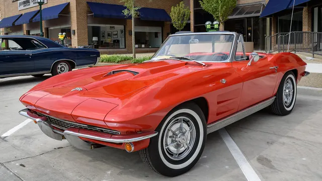 Clean front three-quarter view of a restored red 1963 Corvette convertible.