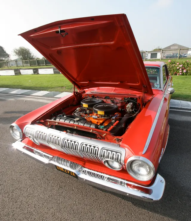 Exact-year Polara Max Wedge engine-bay view retained for the cross-ram dual-quad induction, opposed air cleaners, big-block layout, ignition, cooling, firewall, inner fenders, and hood structure; finishes, service parts, and restoration details remain car-specific.