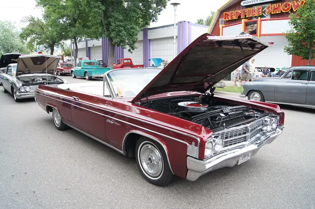 Same exact-year convertible with hood raised, retained for engine-bay layout, air cleaner, radiator support, hoses, accessories, grille, side trim, and convertible context; component originality requires direct inspection.