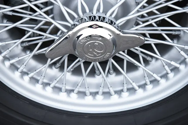 Wire wheel and center-lock knockoff detail on CSX2125; wheel size, finish, hardware, tire, and invoice application must be verified on an individual car.