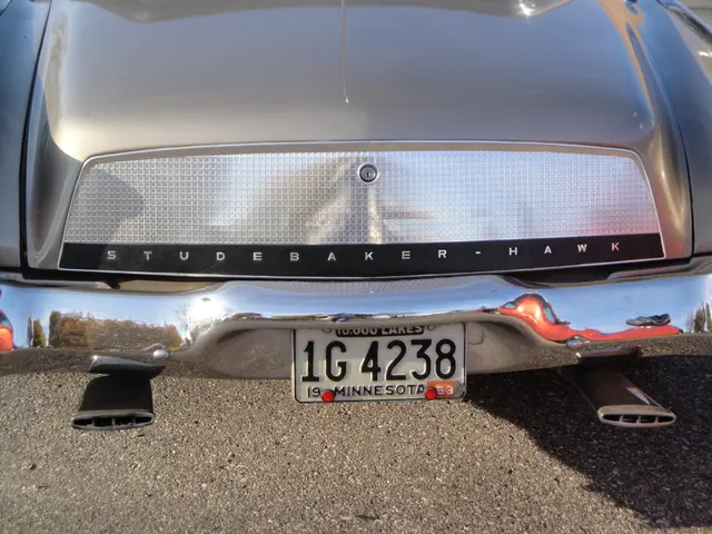Close rear detail showing the smooth black overlay, silver waffle squares, enlarged lettering, deck emblem, trim mounting, and bumper relationship.