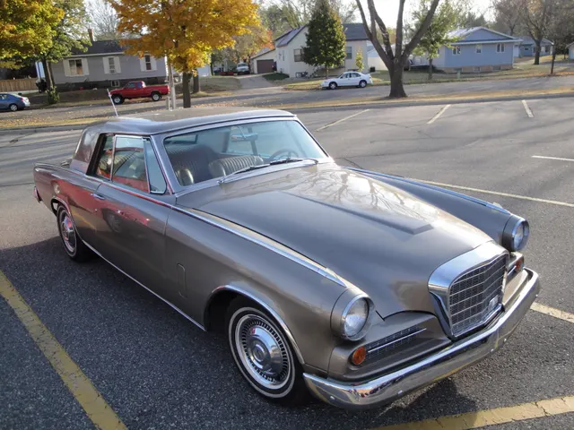 Elevated front three-quarter view documenting the five-bar center grille, mesh side grilles, headlamp rims, hood, bumper, and body proportions.