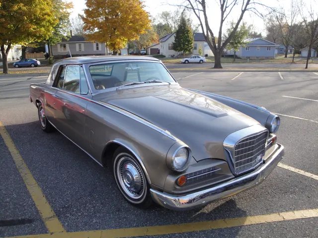 Opposite front three-quarter view showing the 1963 grille and lamp treatment, hood and fender contours, formal roof, rear quarter, wheel covers, and stance.