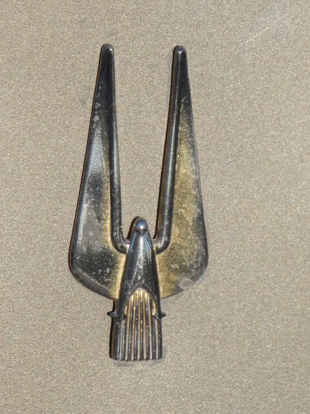 Close detail of the Hawk hood ornament for model-year trim inspection; removable ornament evidence does not establish complete vehicle identity.