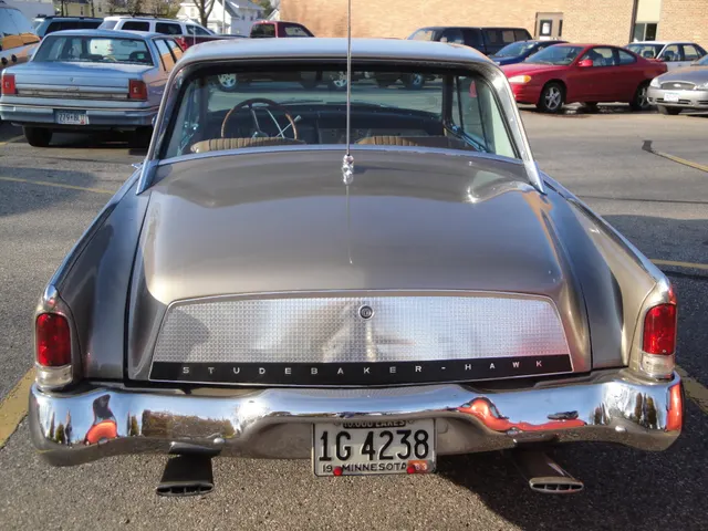 Rear view showing the 1963 deck overlay, enlarged Studebaker Hawk lettering, tricolor Hawk emblem, tail lamps, bumper, and dual exhaust outlets.