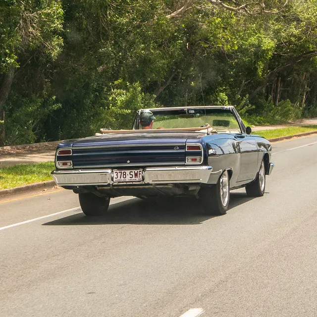 Exact-year stock-presenting view retained for body, trim, glass, lamp, bumper, and wheel context; condition and restoration details remain specific to the photographed car.