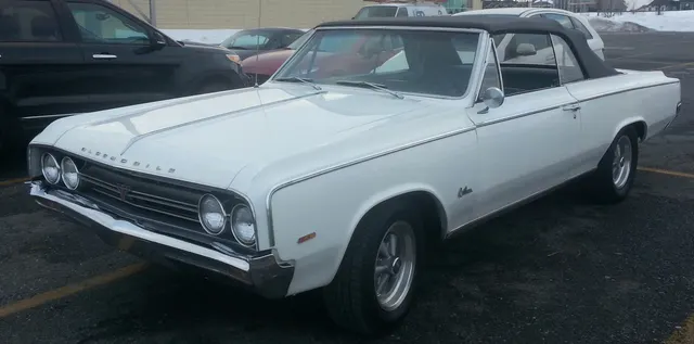 Provincial White 1964 Cutlass 4-4-2 convertible body context; restored car has non-stock wheels