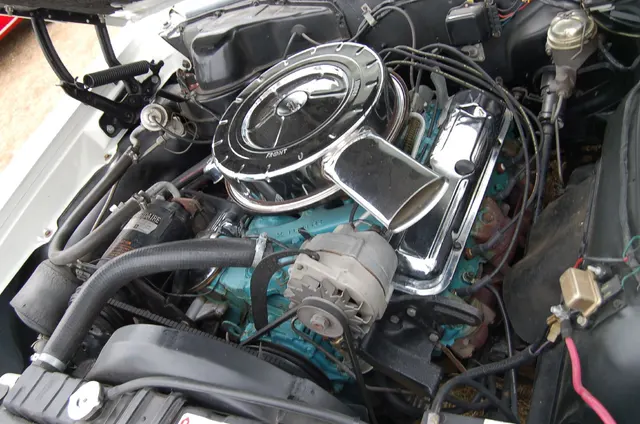 1964 Pontiac GTO engine-bay view; used as engine-bay and component context without individual-car originality claims.