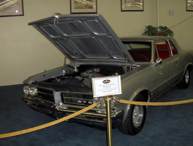 1964 Pontiac GTO Tri-Power display car; used for optional Tri-Power model presentation context.