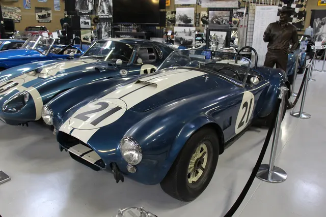 CSX2345, one of five 1964 FIA roadsters, displayed with widened fenders, side exhaust, race wheels, and competition markings. None is generalized to street cars.