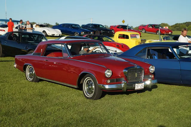 Long front-side view showing the K6 hardtop roof, recessed rear glass, long hood, bright upper-body molding, door script, rear quarter, wheel covers, and five-passenger proportions.