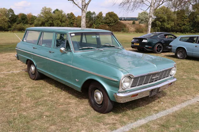 Stock-presenting 1965 Chevy II Nova four-door wagon retained to show the model family's wagon body, roofline, doors, glass, side trim, wheel covers, grille, lamps, and stance; condition remains car-specific.