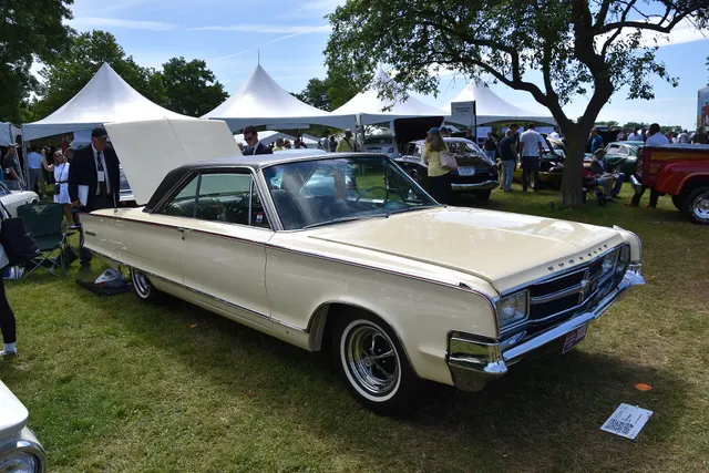 Opposite front three-quarter view documenting the hood, grille, lamps, bumper, molding insert, roof, wheel covers, and hardtop body.