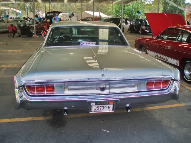 Rear-panel view documenting the damascened insert, tail lamps, Chrysler lettering, bumper, and molding treatment.