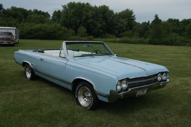 Blue 1965 Oldsmobile 4-4-2 convertible body and trim; restored car has later wheels