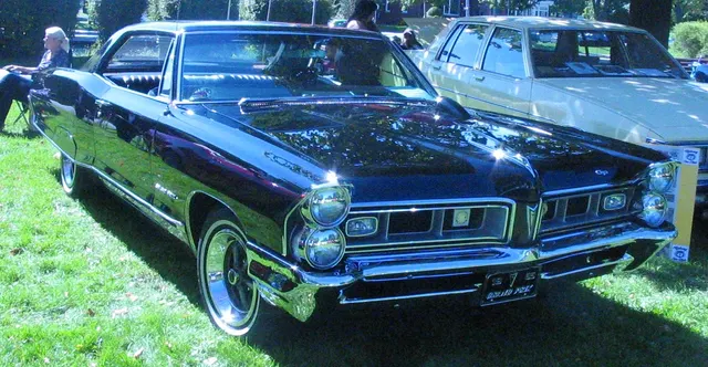 Black 1965 Pontiac Grand Prix in front three-quarter view