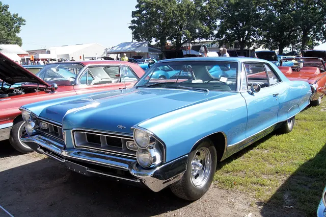 Blue 1965 Pontiac Grand Prix in front three-quarter view