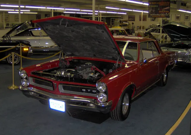 1965 Pontiac GTO Tri-Power display car; used for Tri-Power model presentation context.