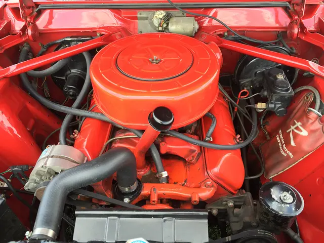 Restored exact-year 327 engine bay showing the V8 installation, air cleaner, intake, brake booster and tandem master cylinder, alternator, shock towers, and cooling layout.