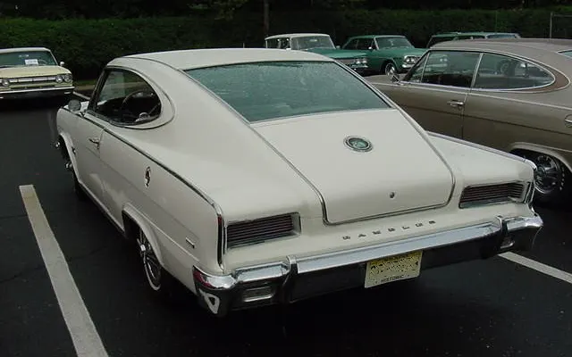 Rear view documenting the sweeping fastback glass, teardrop surround, deck medallion, Marlin script, tunneled tail lamps, bumper, and pillarless roof.