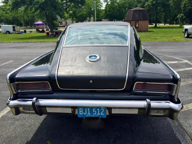 Exact-year rear view documenting the fastback glass, vinyl-covered roof and deck, medallion, Marlin script, tunneled tail lamps, bumper, and trim boundaries.