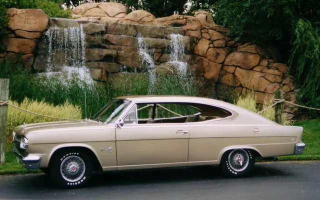 Full side profile of an exact-year four-speed car showing the 112-inch-wheelbase proportions, pillarless opening, fastback roof, teardrop window, side trim, and Marlin emblems.