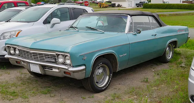 1966 Impala Super Sport convertible in Artesian Turquoise; replacement radial tires are visible and no engine originality is inferred.