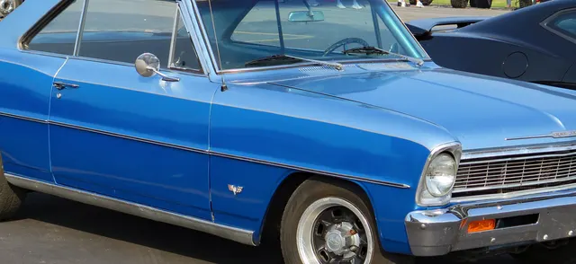 Side crop showing 1966 Nova SS hardtop profile and rocker trim.