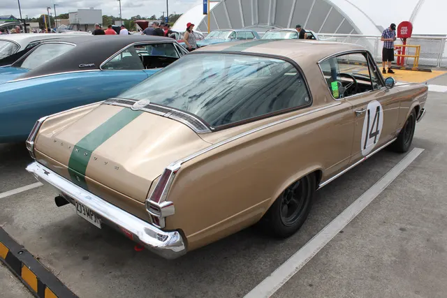 Exact-year competition-prepared Barracuda retained for wraparound glass, rear body, lamps, bumper, and period-use context only; race numbers, stripe, wheels, tires, exhaust, and equipment are not factory-production evidence.