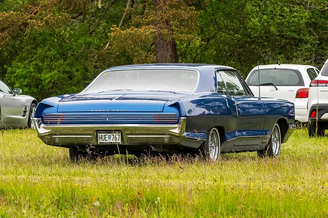 Blue 1966 Pontiac Grand Prix rear treatment with non-stock wheels