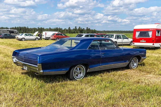 Blue 1966 Pontiac Grand Prix rear view with non-stock wheels