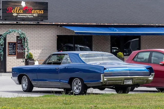 Blue 1966 Pontiac Grand Prix rear three-quarter view with non-stock wheels