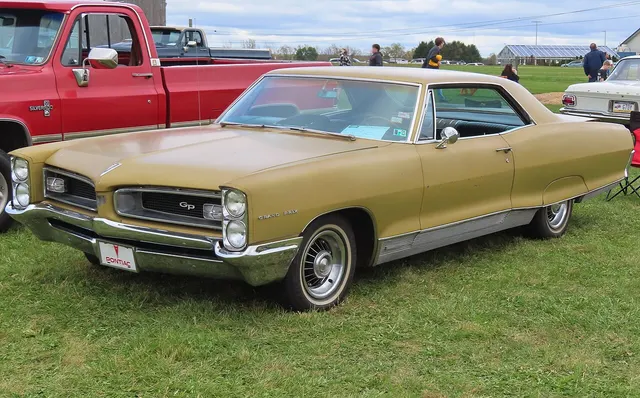 Gold 1966 Pontiac Grand Prix in front three-quarter view