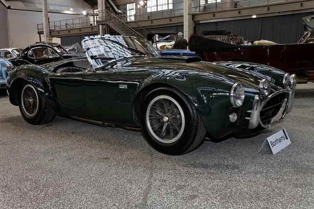 Side profile of the documented 1966 street roadster showing the 90-inch-wheelbase proportions, wide fenders, side vents, and under-car exhaust context.