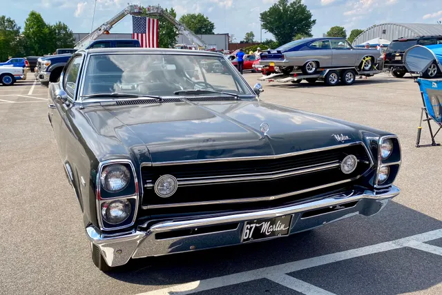 Exact-year frontal view documenting the stacked headlamps, grille rally lights, hood script and ornament, bumper, and 1967 front sheet metal.