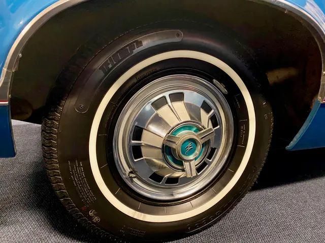 Exact-year Marlin wheel-cover detail showing the M-emblem spinner treatment and whitewall tire; tire brand and service replacement remain subject-specific.