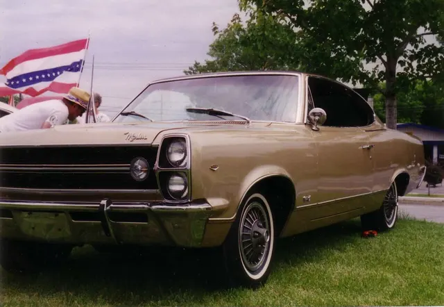 Exact-year front three-quarter view showing the Marlin hood script, stacked headlamps, grille, 343 fender emblem, bumper, fastback roof, and factory-style wheel covers.