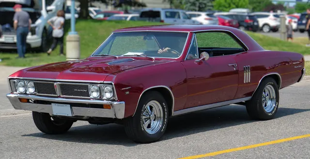 Exact-year later Sport Deluxe front and side view retained only to explain the model-year transition from early Custom Sports Option equipment to separate 738-series identity. Wheels and tires are subject-specific.