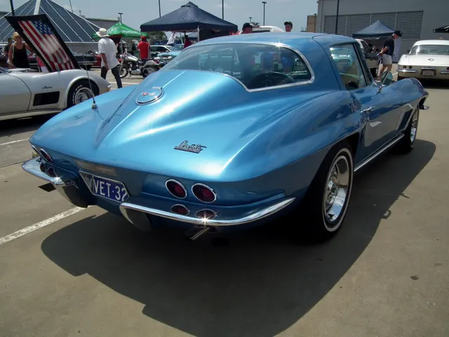 Rear view of the blue coupe showing the 1967 backup-lamp location, fuel door, taillamps, bumpers, and fastback glass.