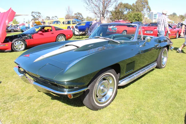 Green 427-style convertible showing the open body, stinger hood, side exhaust, and final-year fender treatment.