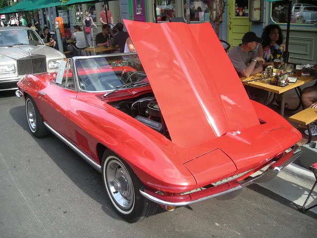 Red convertible with its hood raised, preserving body and engine-compartment context without treating visible equipment as authentication.