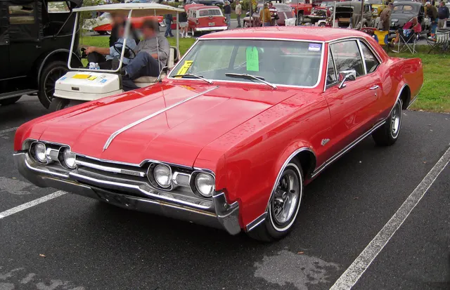 Exact-year, stock-presenting 1967 Oldsmobile 4-4-2 retained for a distinct front angle, body, grille, brightwork, wheels, and stance; the photograph does not establish W-30 equipment.