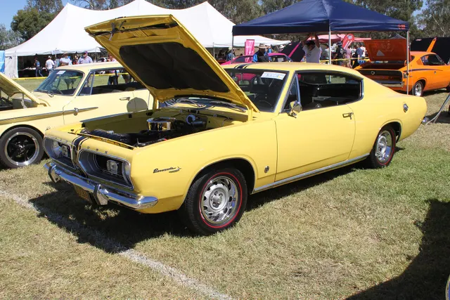 Exact-year fastback front three-quarter and open-hood view retained for body, grille, glass, cabin, and engine-bay layout context; induction, finishes, hoses, and restoration details remain subject-specific.