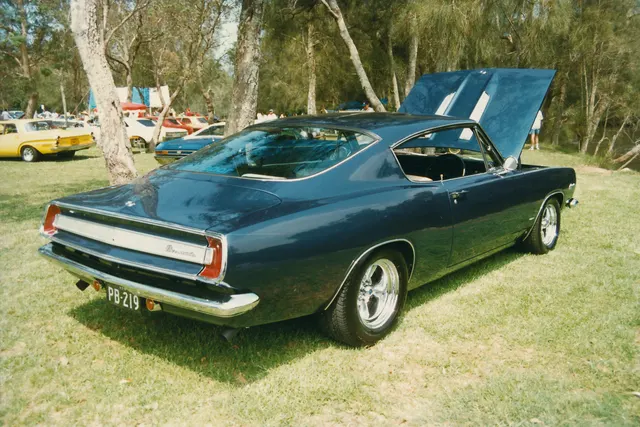 Exact-year fastback rear three-quarter view retained for roof, glass, deck, lamp panel, bumper, and body context; wheels, tires, exhaust, and engine-bay presentation are subject-specific.
