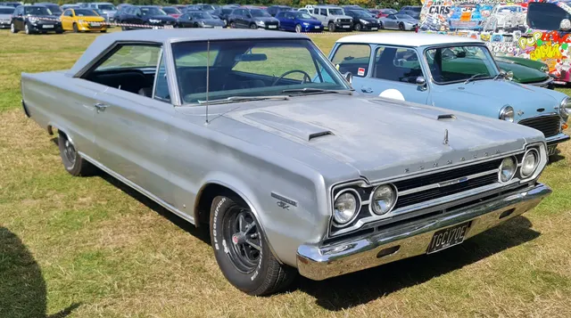 1967 Plymouth GTX front three-quarter view with stock-scale hood scoops and blacked-out grille